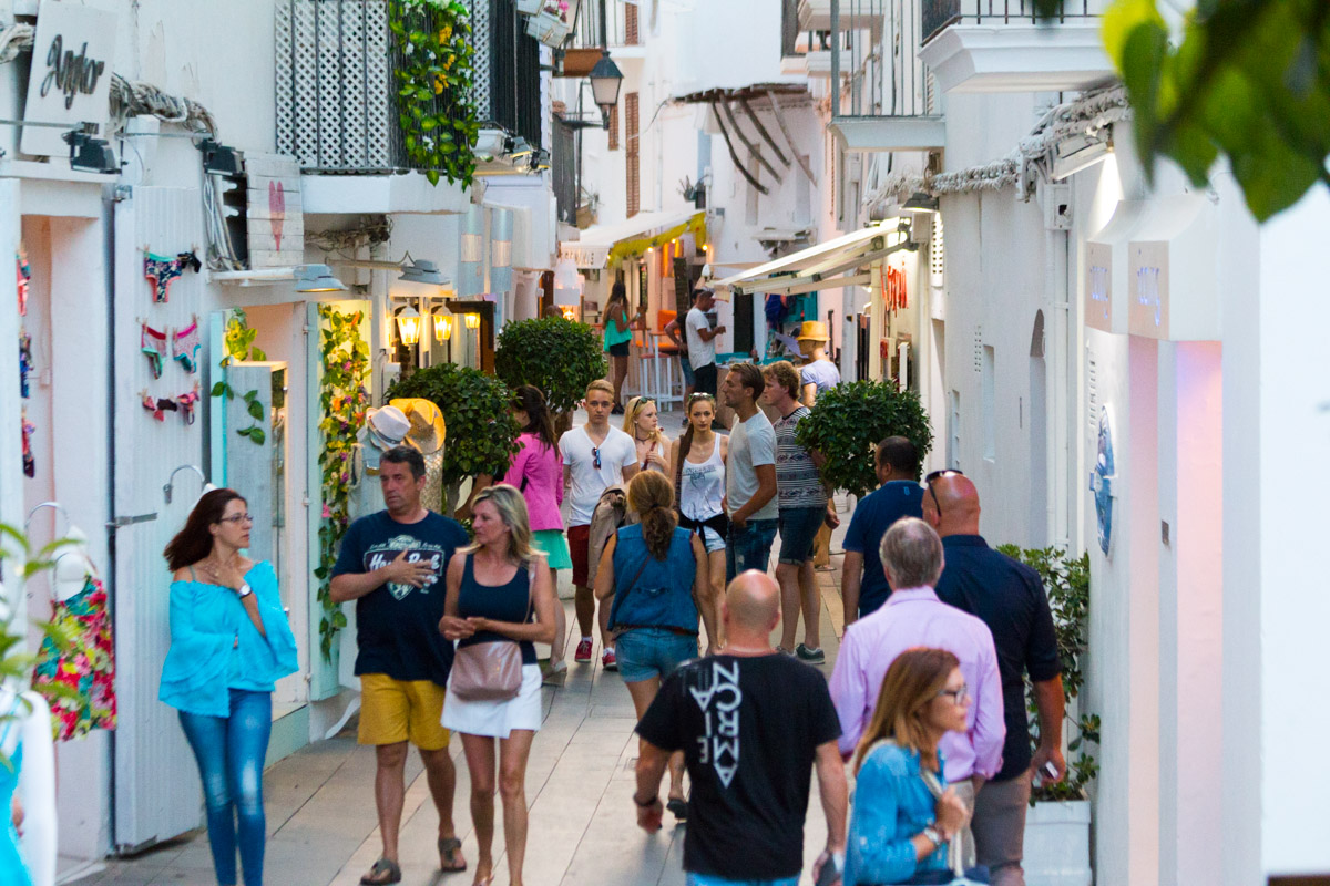 Ibiza Spain- June 10 2017: Tourists walking in the charming whitewashed narrow street in Ibiza old town. Balearic Islands. Spain